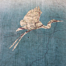 Load image into Gallery viewer, dettaglio di pannello decorativo in legno tinto fondo turchese, soggetto VIAGGIO con airone
